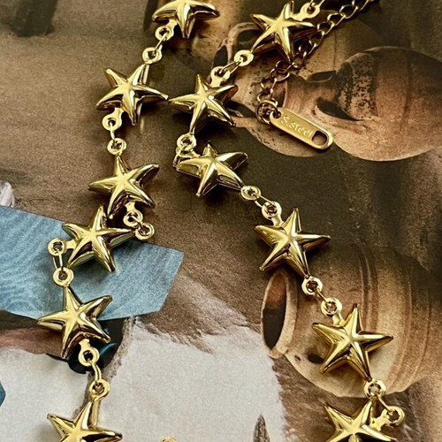 Steel necklace with gold stars, new