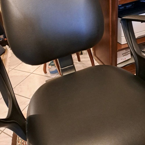 Office chair used with black leatherette upholstery