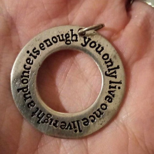 Silver pendant used with engraved quote