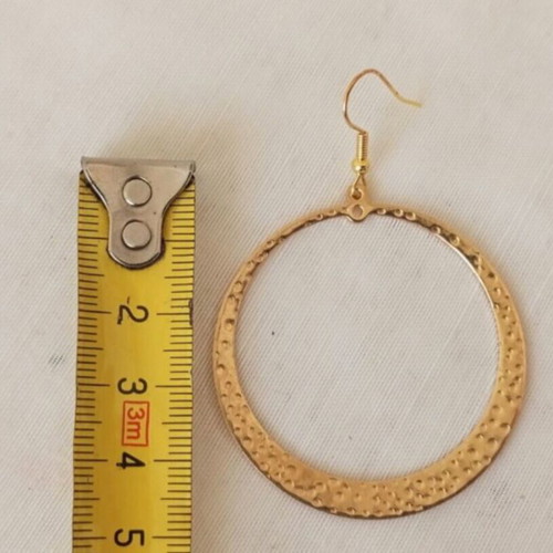 Large gold-tone hoop earrings with embossed hammered surface