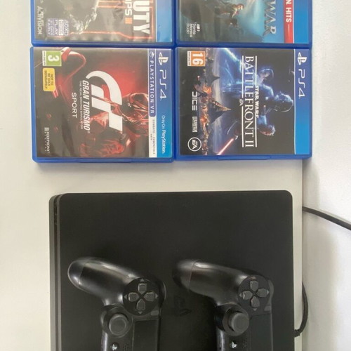 PlayStation 4 Slim 500GB used with 2 controllers and 4 games