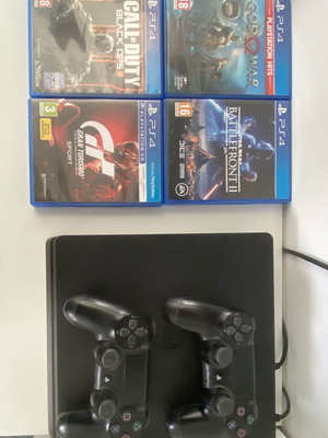 PlayStation 4 Slim 500GB used with 2 controllers and 4 games
