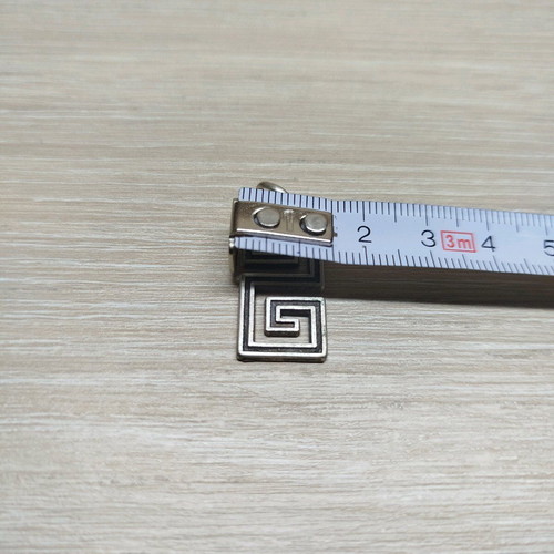 Pendant with double Meander like new, silver color