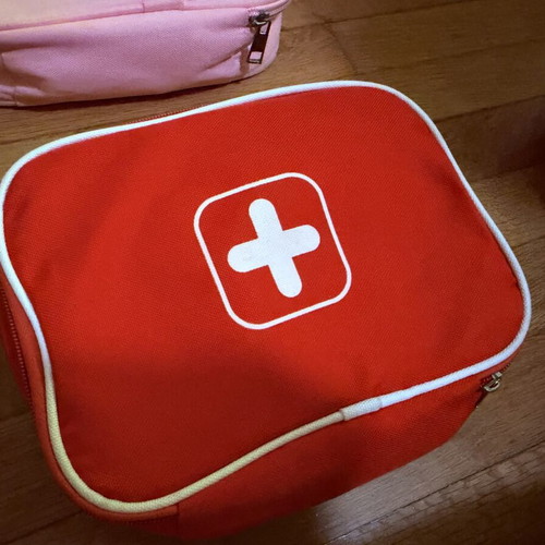 Wooden doctor playset with red first aid bag, used
