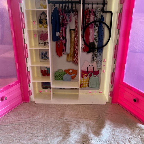 Barbie wardrobe in like new condition with dolls and clothes