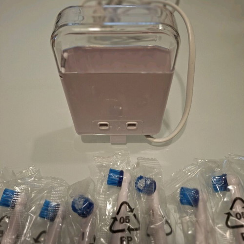 Nevadent charger and 8 new replacement heads
