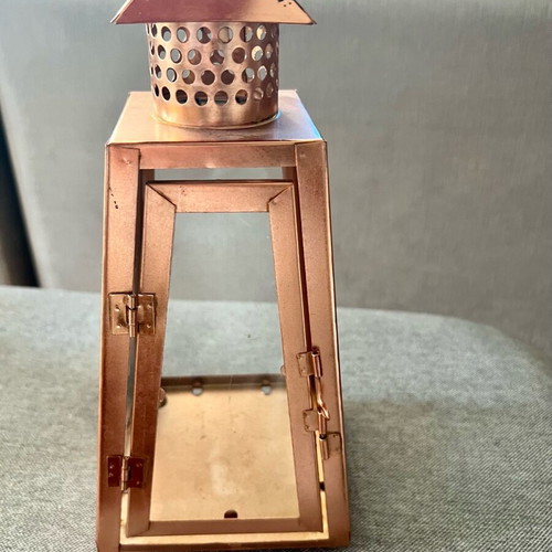 Metal candle lantern used, copper color