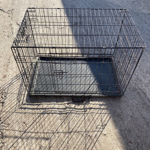 Dog crate used for a large dog with two doors and cleaning tray