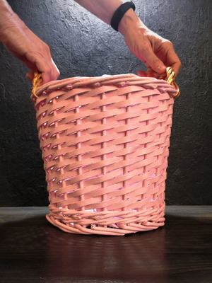 Decorative pink rattan basket with gold handles, handmade