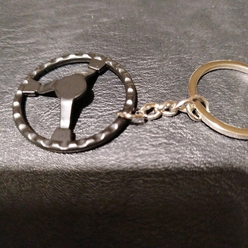 Metal car keychain new with sporting black red steering wheel design