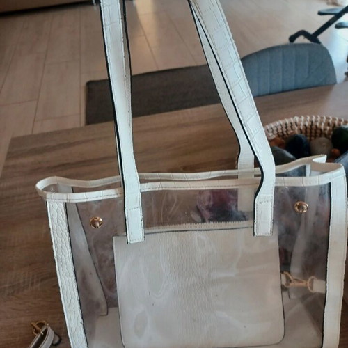 Transparent white bag used, shoulder and hand