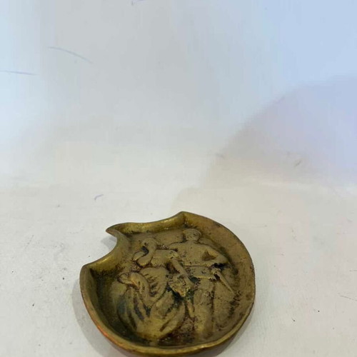 Vintage brass ashtray with embossed World War I scene used