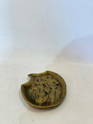 Vintage brass ashtray with embossed World War I scene used