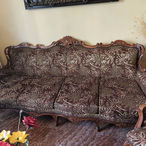 Classic living room refurbished with sofa, armchairs, chairs and marble tables