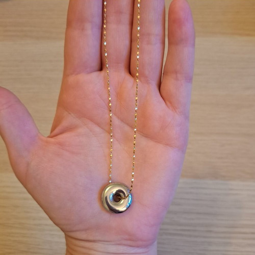 Necklace with gold tone chain and silver round pendant like new