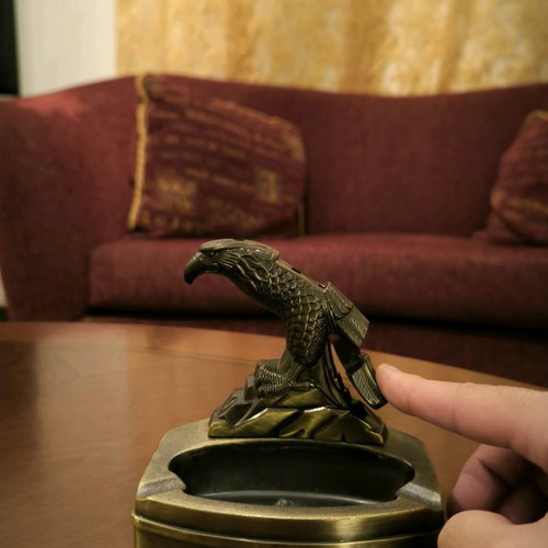 Metal ashtray lighter with two cigarette slots and plastic bird