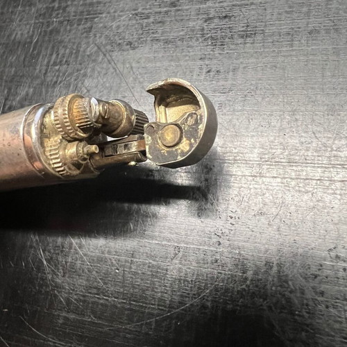 Silver lighter used, unknown if working