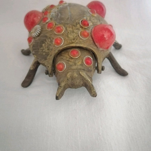 Bronze ashtray used with red scarab-shaped stones