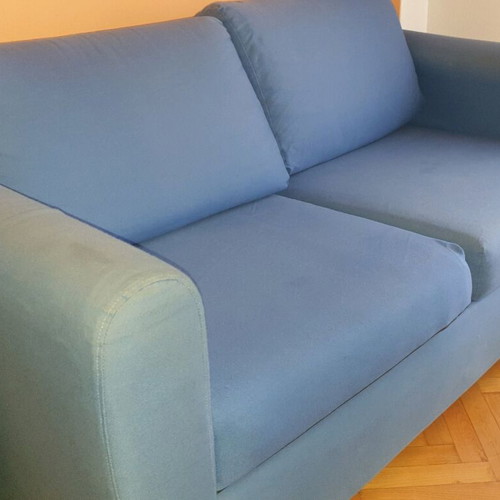 Two-seater sofa used without two back cushions