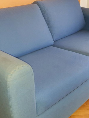 Two-seater sofa used without two back cushions
