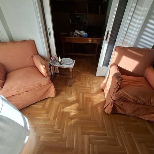 Vintage three-seater sofa and two antique armchairs with dark wood frame