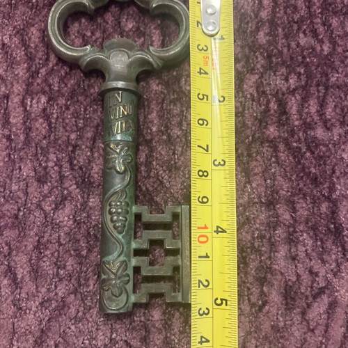 Vintage bottle opener used with patina, brass and steel
