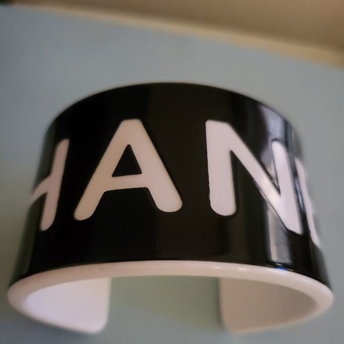 Cuff bracelet like new, black resin with white letters