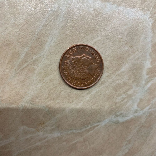 Coins one penny 2010 and five pence 1991 used