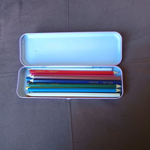 Metal pencil case with colored pencils used