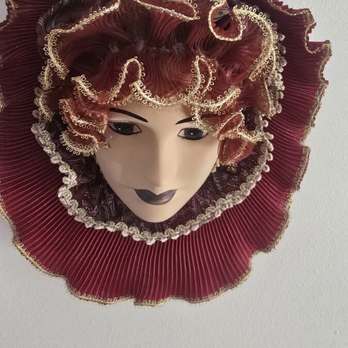 Decorative porcelain wall mask used with fabric hat in burgundy
