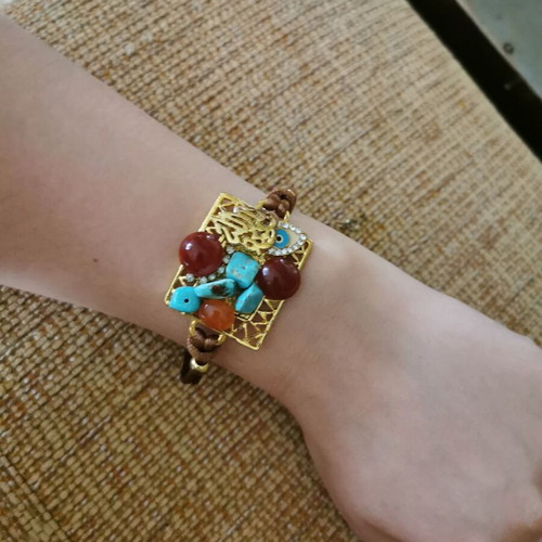 Women's bracelet like new with gold clasp and orange-blue stones