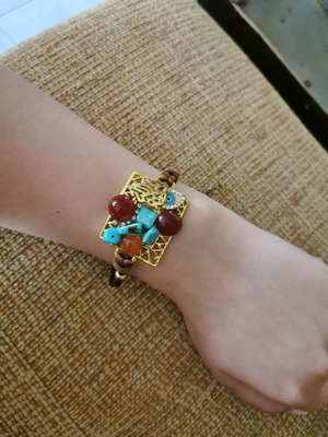 Women's bracelet like new with gold clasp and orange-blue stones