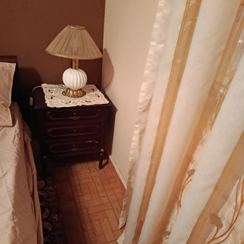 Double bed with two nightstands, mirror and unused mattress