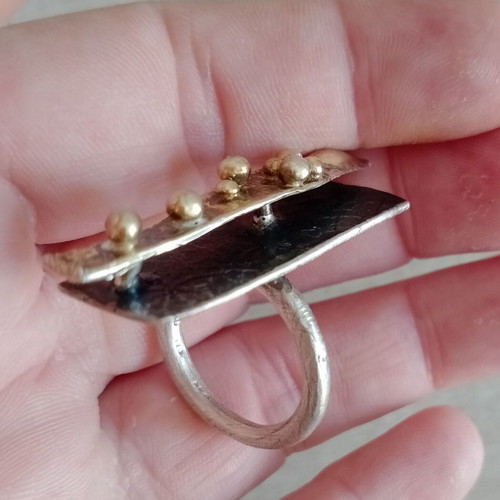 Statement two-tone ring used with layers, silver and gold colors