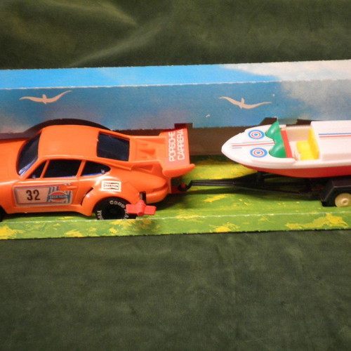 Winding Porsche Carrera car with Cris-Craft and trailer new