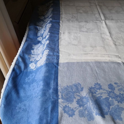 Aegean blue cotton tablecloth with floral woven patterns and lace trim