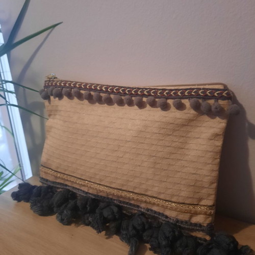 Handmade handbag used with gray tassels and golden details
