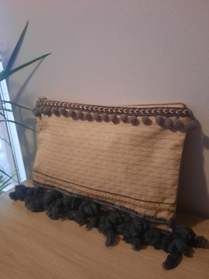 Handmade handbag used with gray tassels and golden details