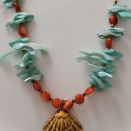 Necklace with shell chips and steel clam pendant