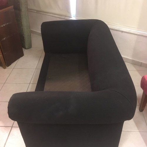 Two-seater black sofa used with wooden legs and washable fabric