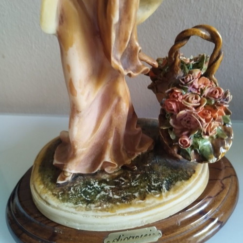 Vintage Italian decorative statue of a girl with roses, used