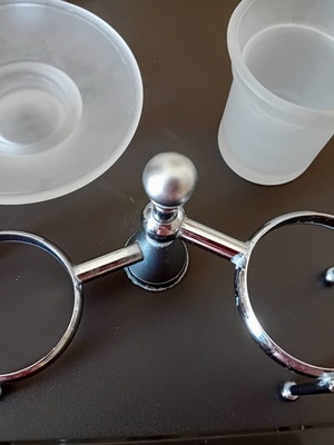 Two sets of inox bathroom accessories with glass and frosted parts