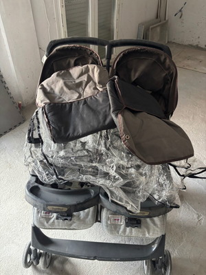 Peg Perego twin stroller used with rain cover and mosquito net