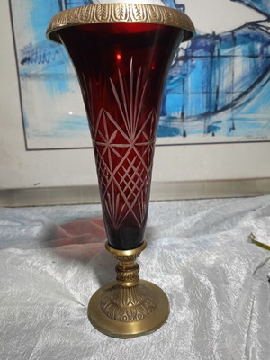 Vintage red glass vase with cut designs and decorative brass base and rim