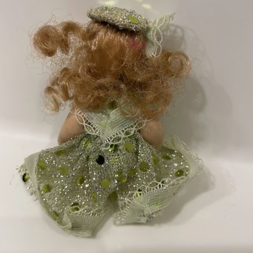 Porcelain doll keychain like new, green, 7cm with movable arms and legs