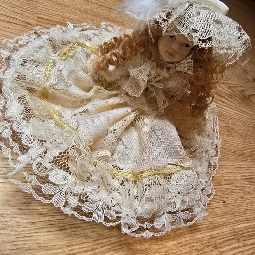 Glass bride doll like new with hat and lace