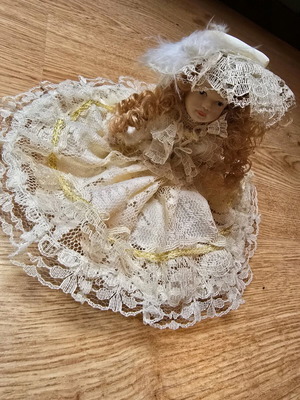 Glass bride doll like new with hat and lace