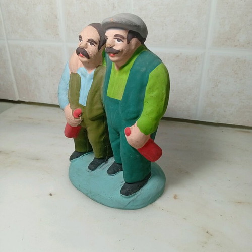 Ceramic figure of two men with traditional costumes like new