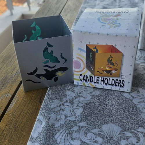 Metal tealight holder with stained glass dolphins