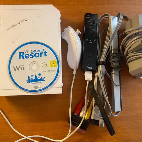Nintendo Wii used with Wii Sports Resort game and accessories in moderate condition